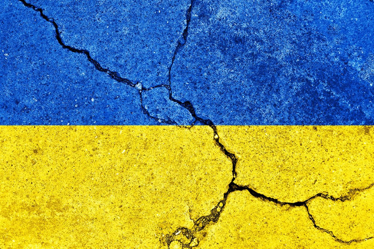 Ukraine flag with a visible crack running through it.