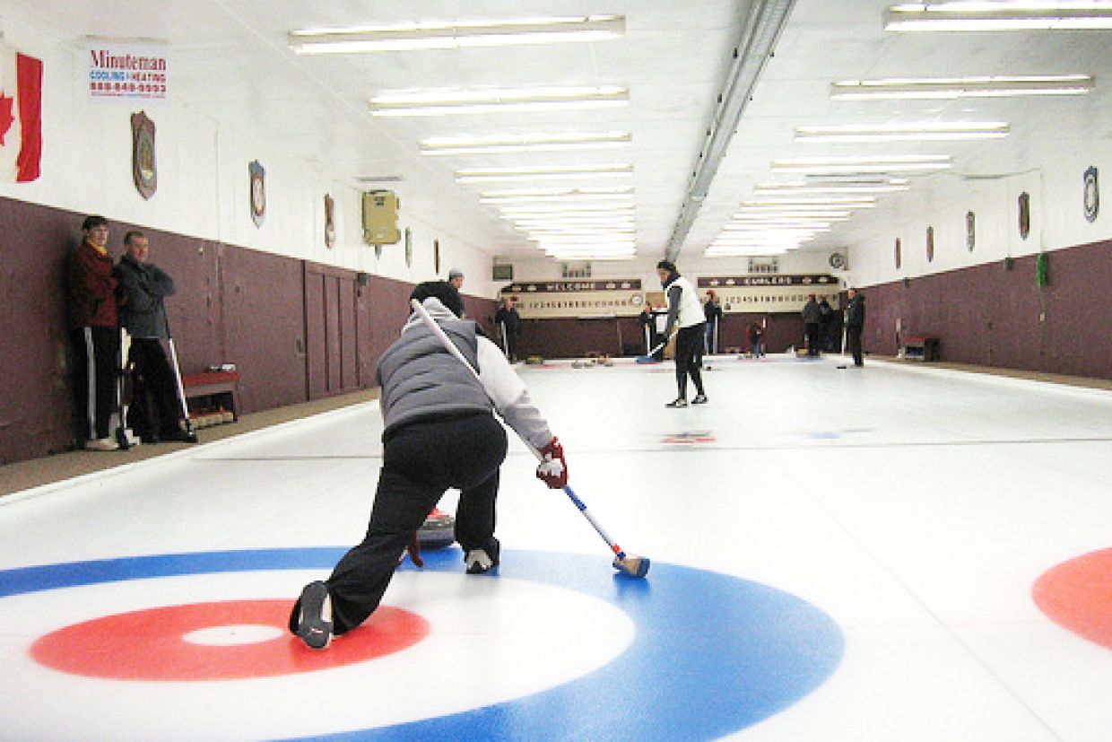 curler throwing rock