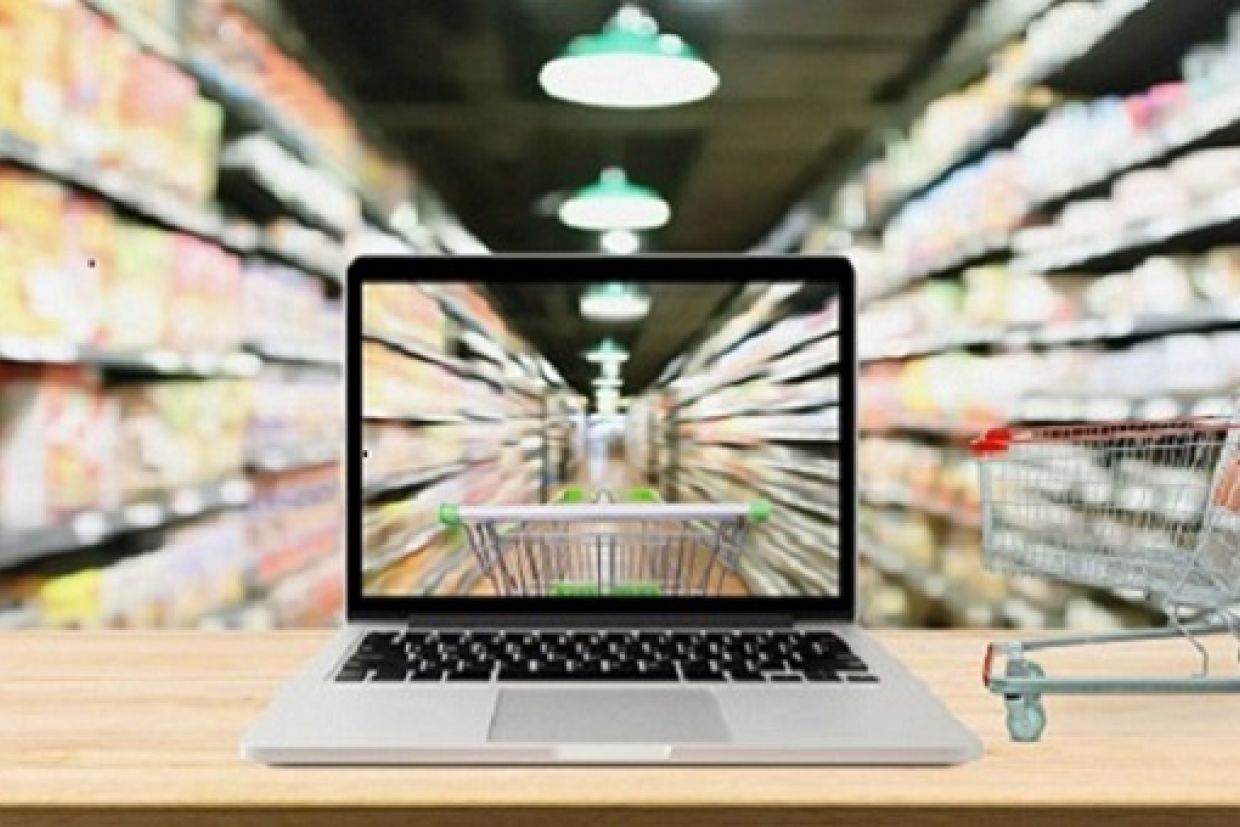 A grocery store aisle with a laptop in view.