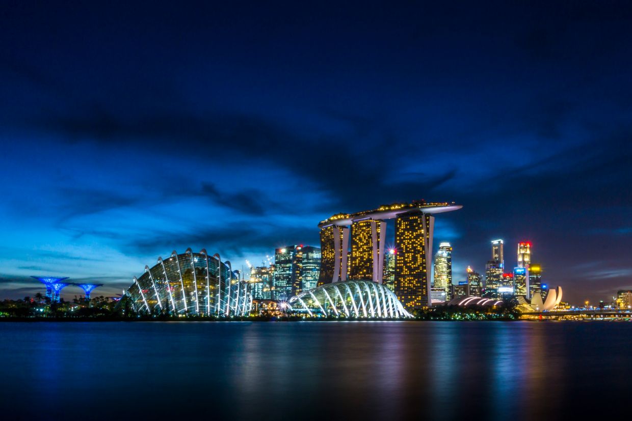 Singapore skyline at dusk. Buildings on the water.