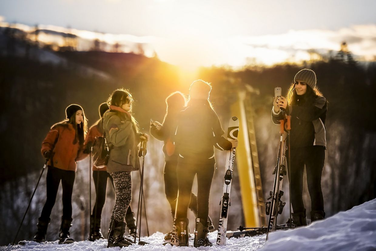 People taking a photo on a ski hill