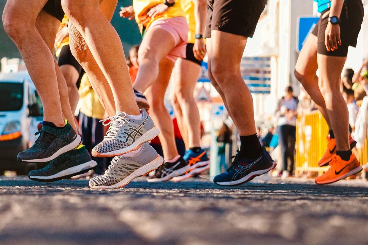 Cropped shot of the legs of runners at a start line before a run