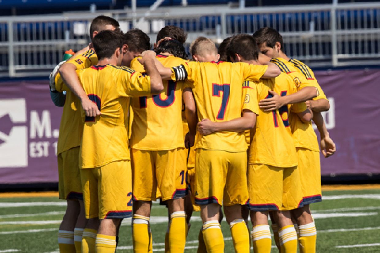 men's soccer team huddled 