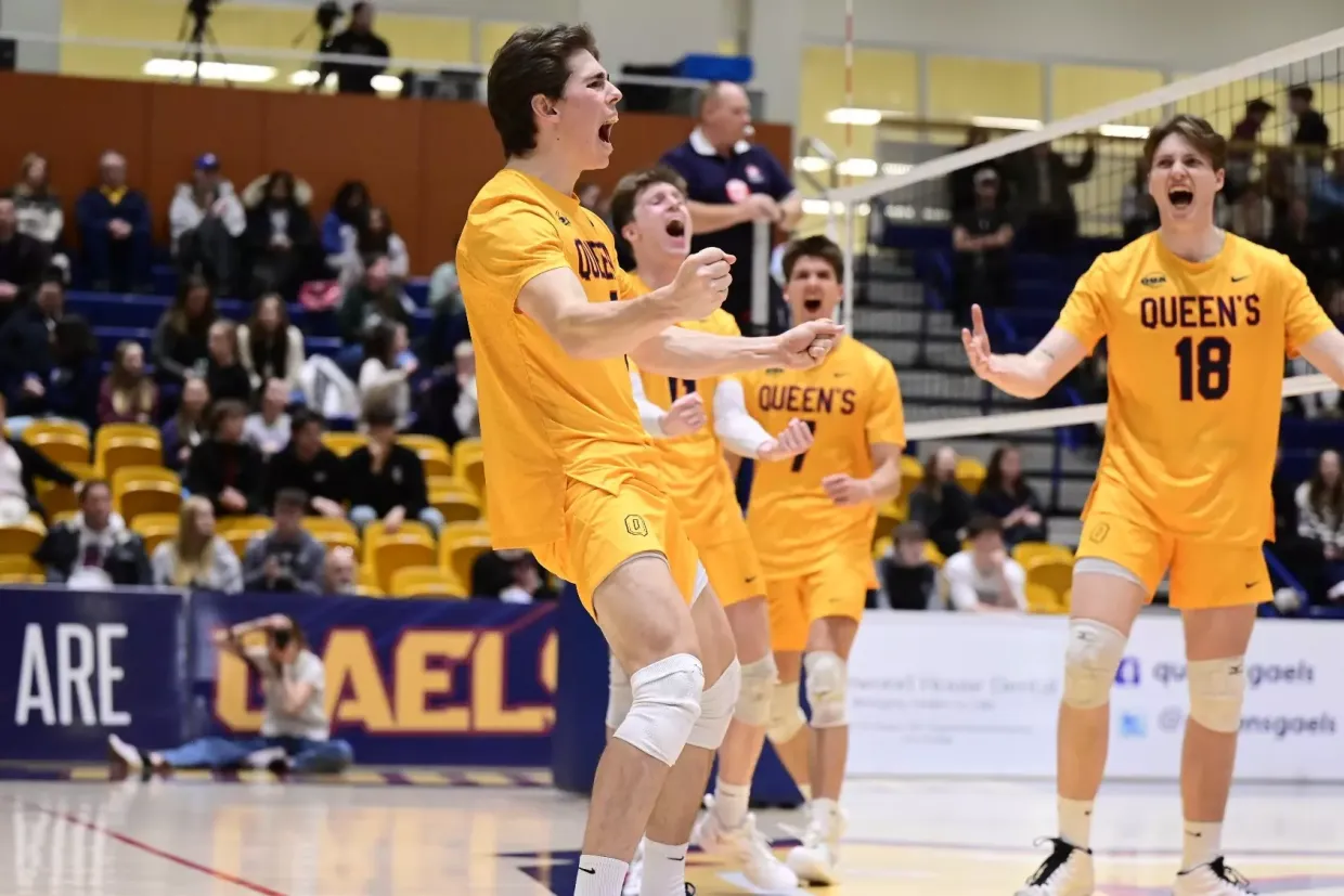 Queen's University Men's Volleyball celebrate a point victory at the ARC Main Gym.