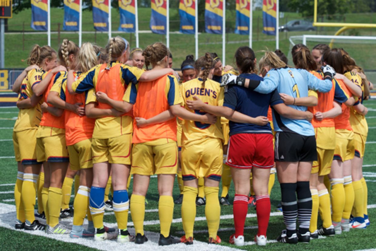 Women's soccer team huddled