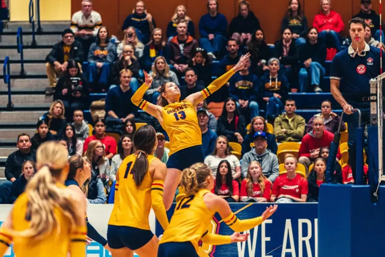Abigail McAlpine from Queen's University jumps up for a spike near the net.