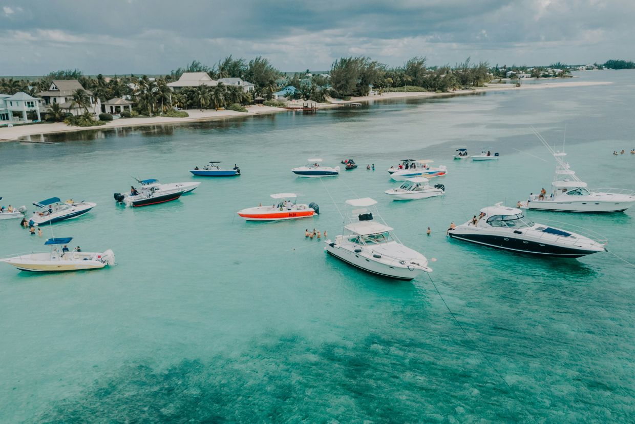 Boats anchored in the water near the shoreline in Grand Cayman.