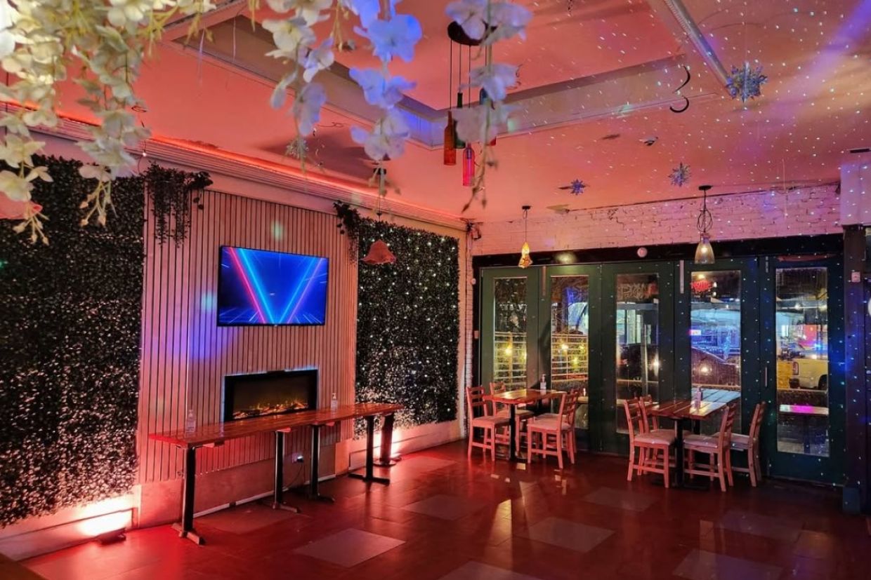 Taco Taco dining space with pink ambient lighting. 