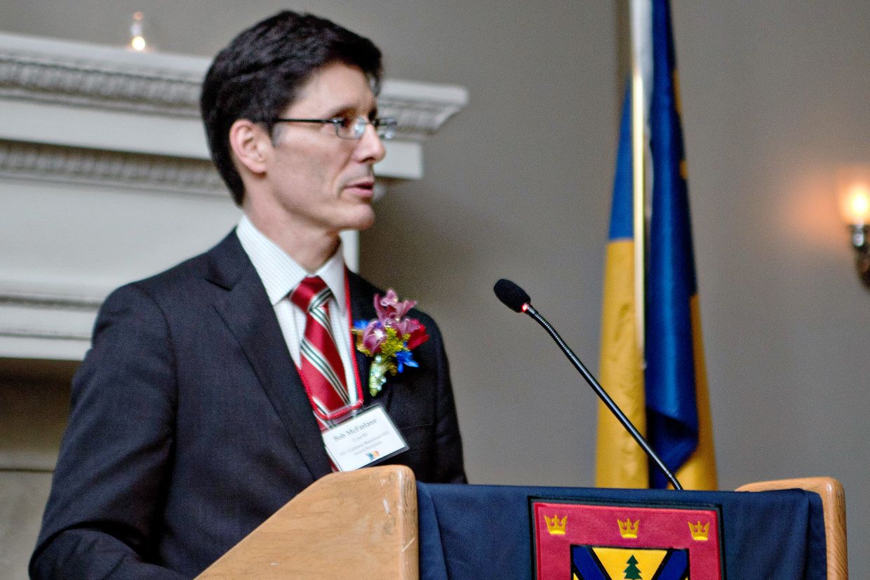 Photo of Bob McFarlane speaking at a podium.