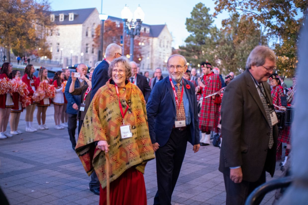 Members of Tricolour Guard in formal attire enter Grant Hall.
