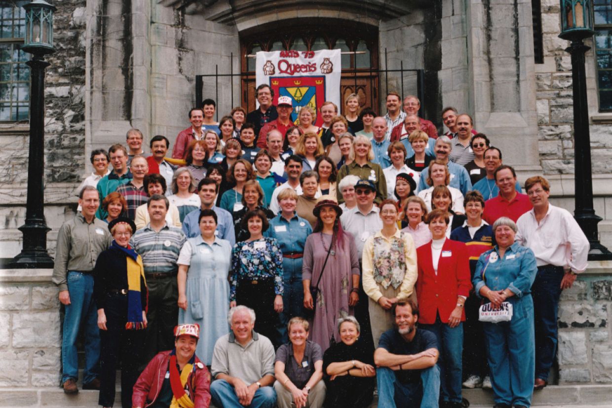 Artsci'73 alumni standing in front of Douglas Library smiling for their class photo