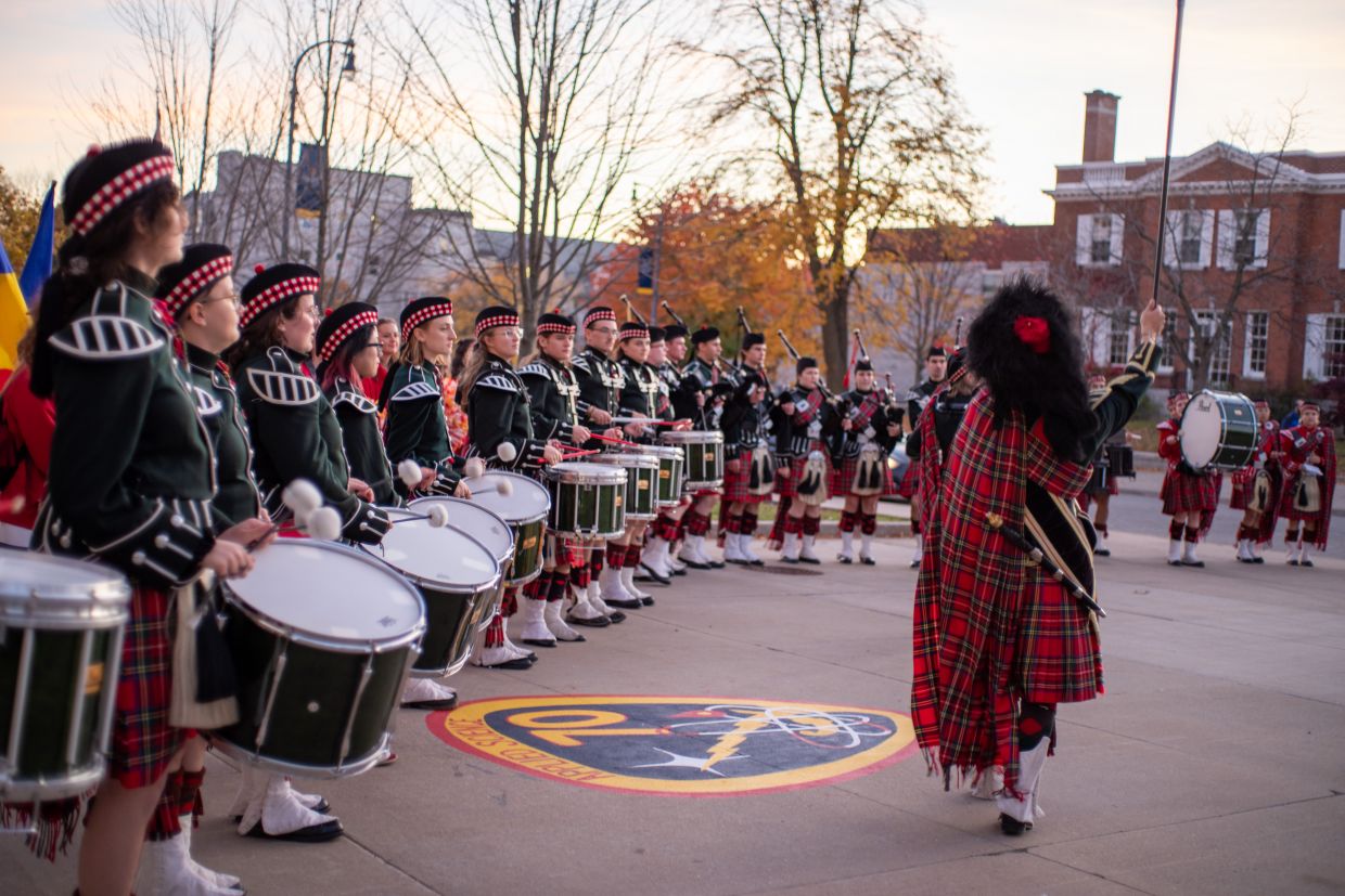 Queen's Bands Pipe and Drum line standing ready to begin playing