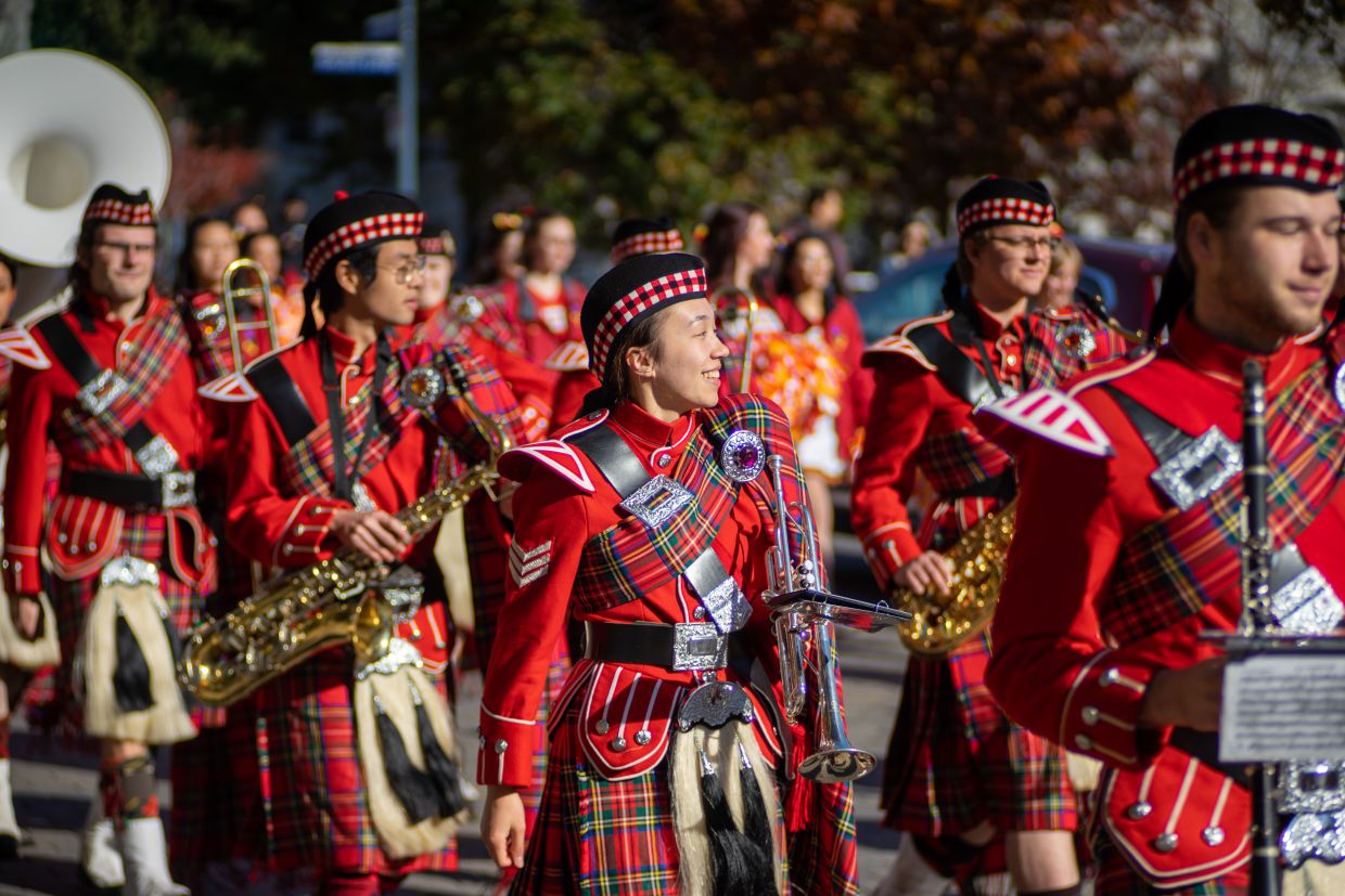 Bands members in parade out to Richardson Stadium on a sunny day