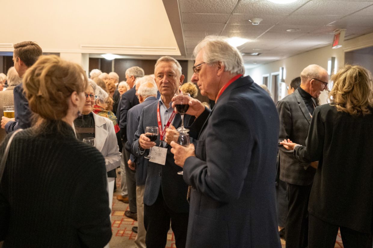 Alumni mingling and engaged in conversation