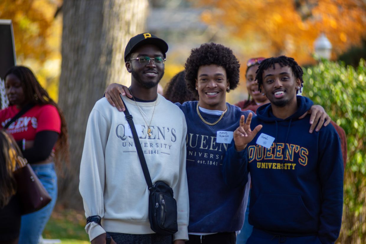 Members of Queen's Black Alumni Chapter smile outside the Summerhill building