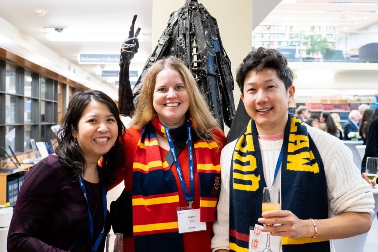 Alumni at an event posting for a photo together 