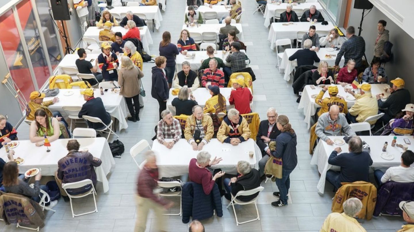 Aerial view of alumni sitting at tables during breakfast