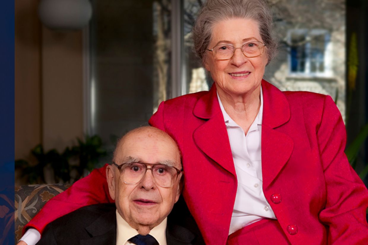 Alfred and Isabel Bader sit together on a chair.