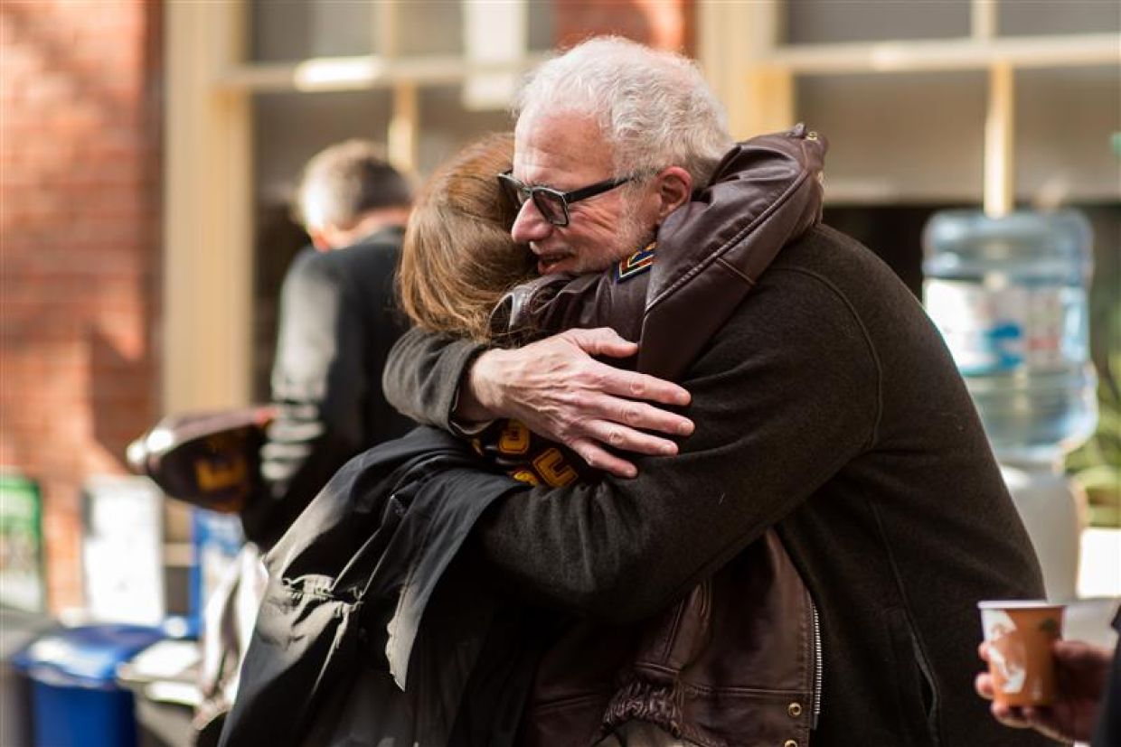 Two people hugging at Homecoming at Queen's University. 
