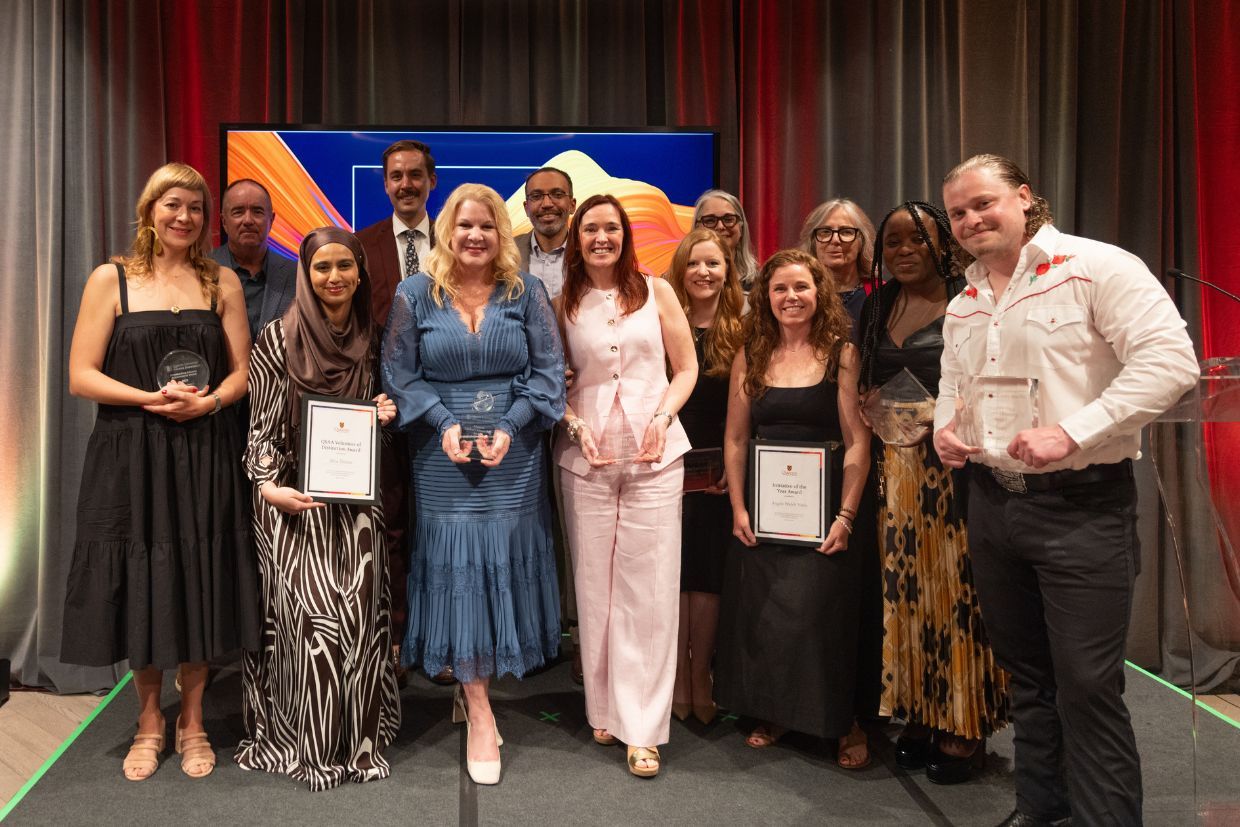 A diverse group of individuals holds their awards on stage at the 2025 QUAA Gala Awards in Toronto, June 19, 2025.