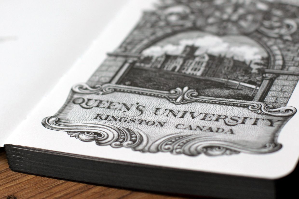 Open notebook with Queen's University illustration