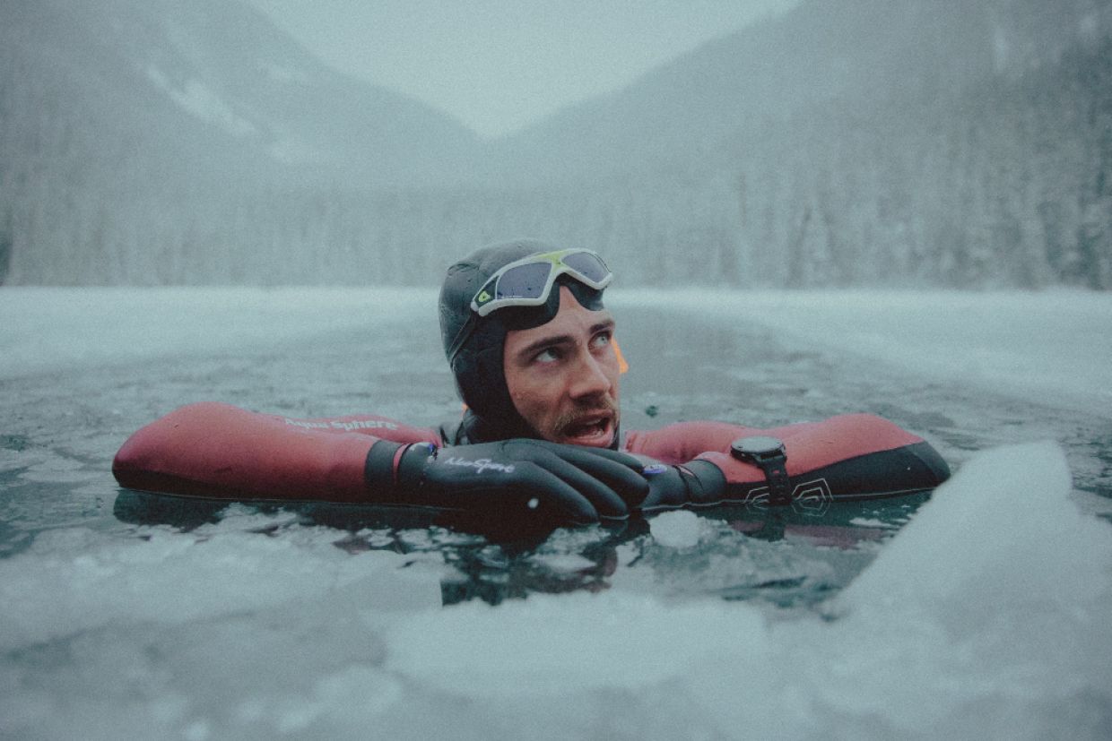 Connor Emeny swims in a frozen lake.