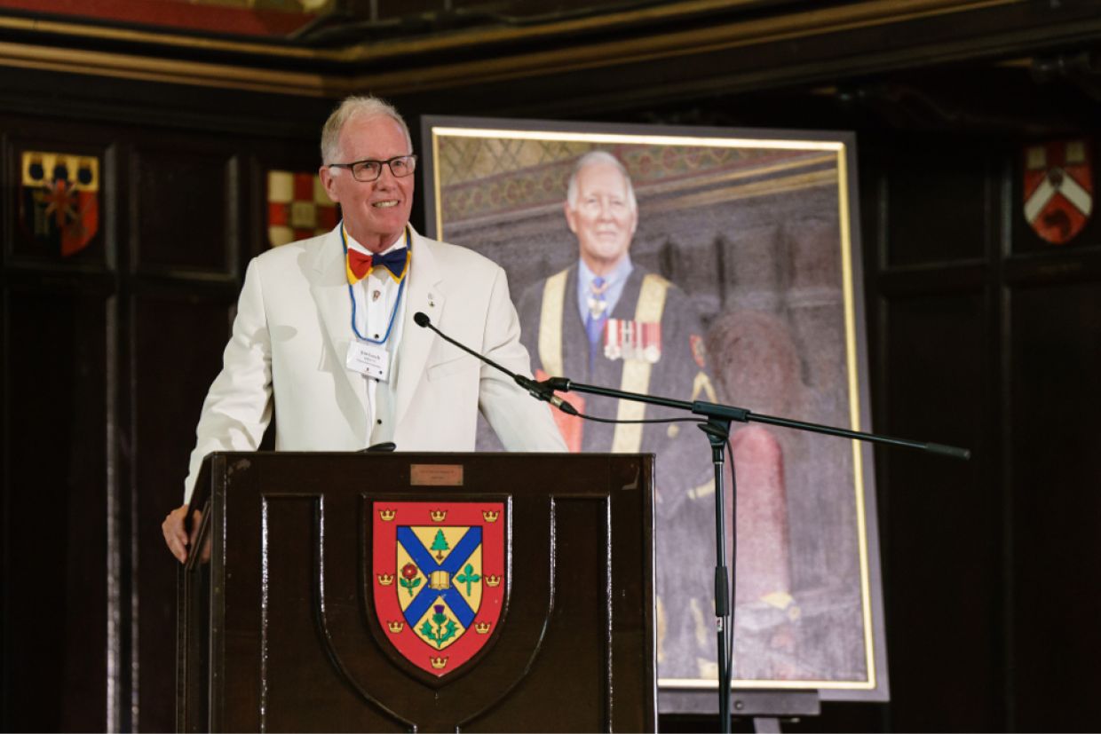 Chancellor Emeritus Jim Leech, MBA’73, stands in front of his official portrait during his farewell celebration in Grant Hall on June 24.