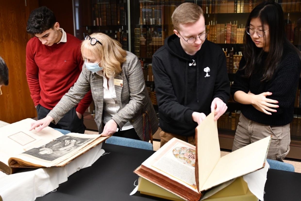 Schulich Scholars examining books