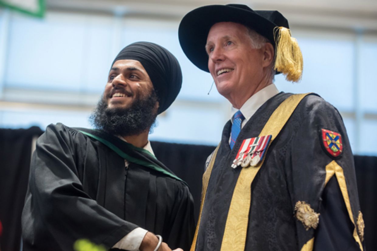 Chancellor Jim Leech at Convocation with graduate 