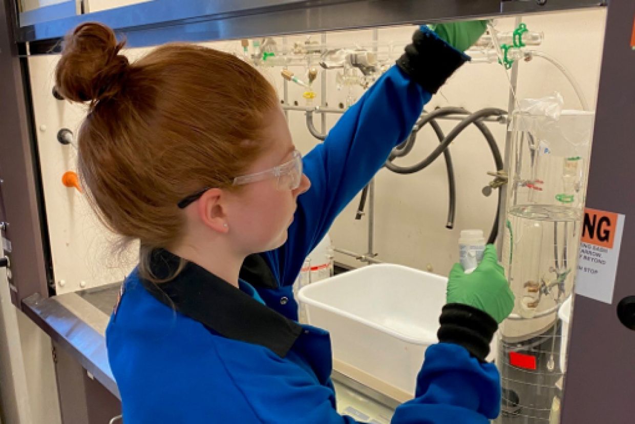 Department of Chemistry graduate student Hailey Poole takes samples from a prototype batch of sanitizer.