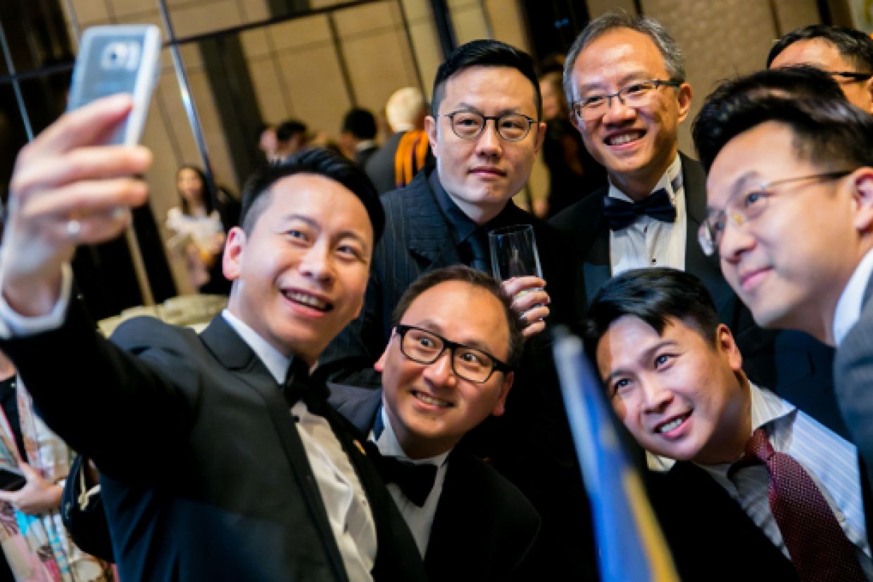 Alumni taking a photo together at the Hong Kong reception 