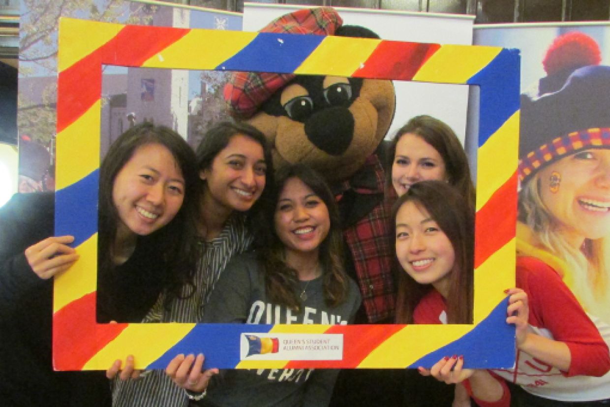 New grads posing with Boo Hoo