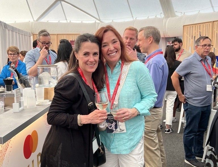two alumni smiling for photo