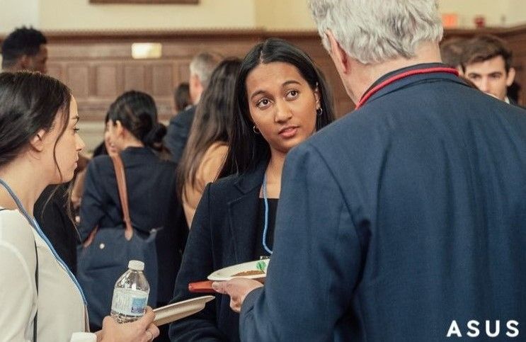 Two students in a networking discussion with an ArtSci Alumni at Life After ArtSci event