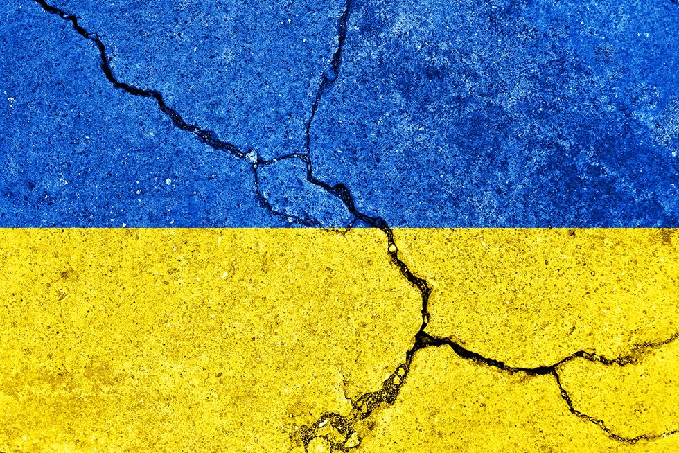 Ukraine flag on concrete with cracks