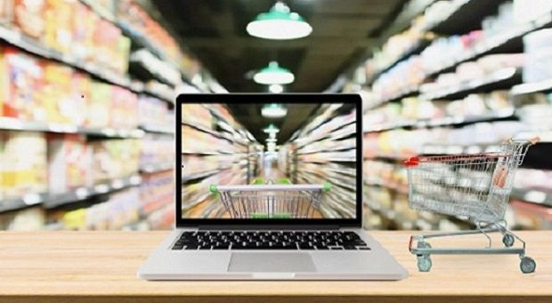 A grocery store aisle with a laptop in view.