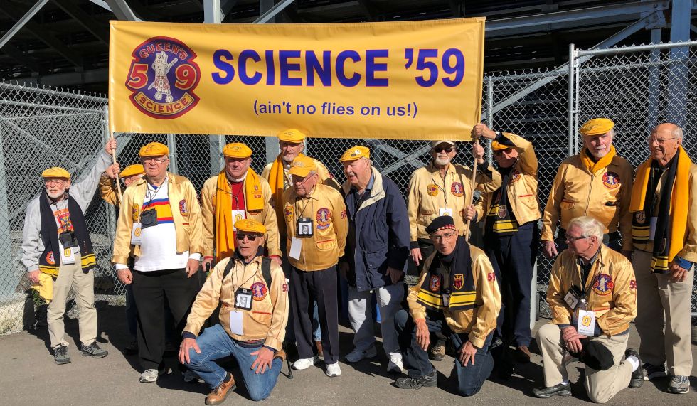 Members of Sc'59 gathered around their class banner that reads "Science '59 Ain't no flies on me"