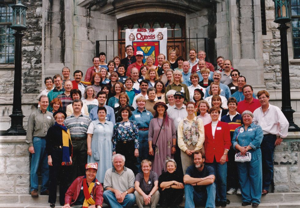 Artsci'73 alumni standing in front of Douglas Library smiling for their class photo