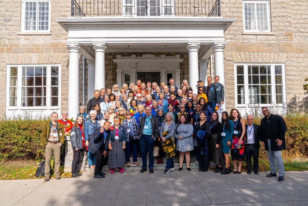 Students and alumni pose outside in front of the donald gordon conference centre