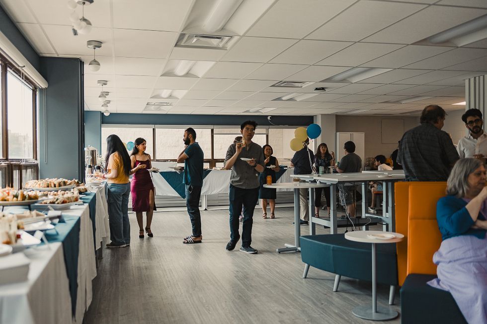 Alumni chat in groups at a reception