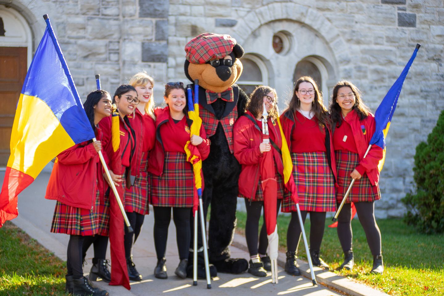 Boo Hoo standing in front of Grant Hall with several Bands members, smiling at the camera.