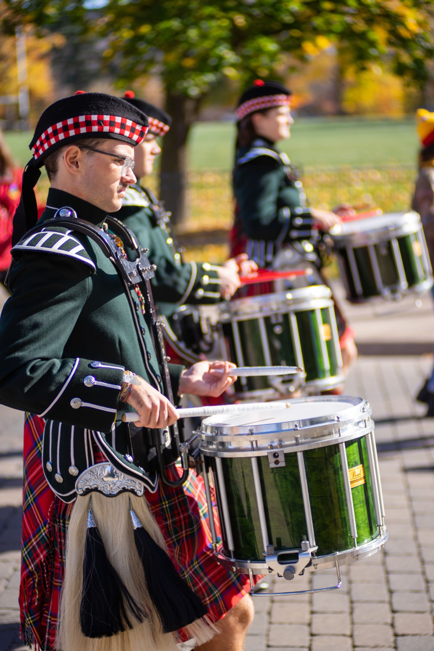 Drummers walking in the alumni parade to Richardson Stadium