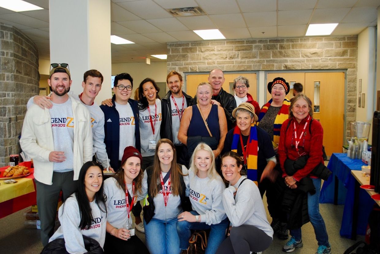 alumni and students pose in the Kinesiology and Health Studies building lobby
