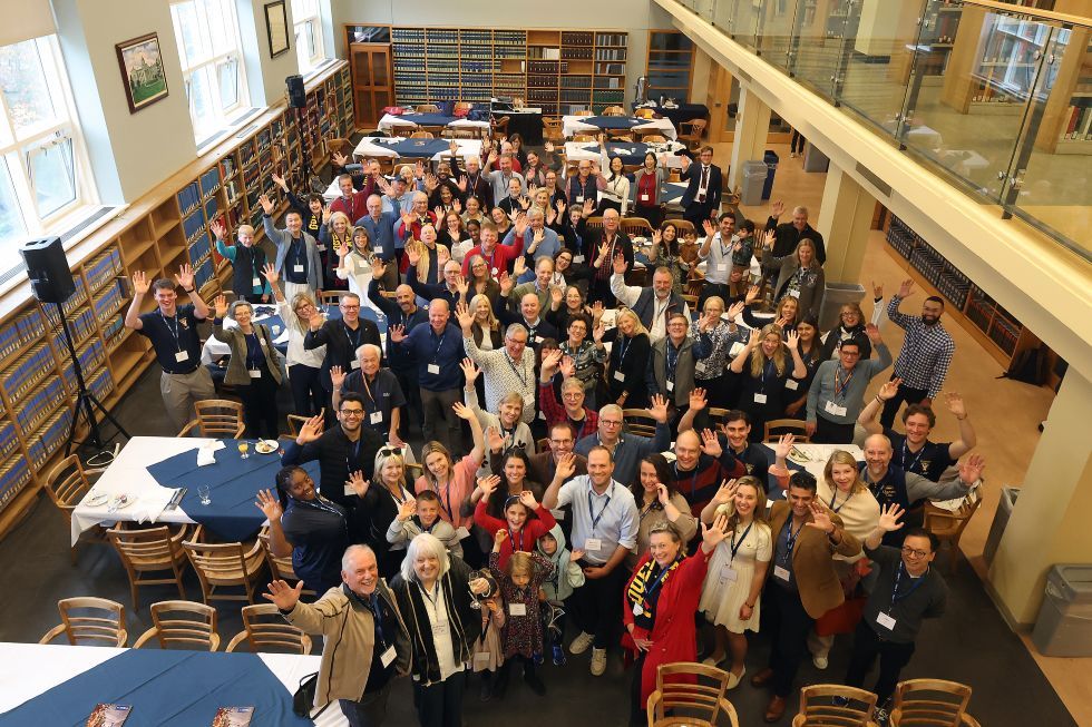 aerial shot of law alumni pose in the law library 