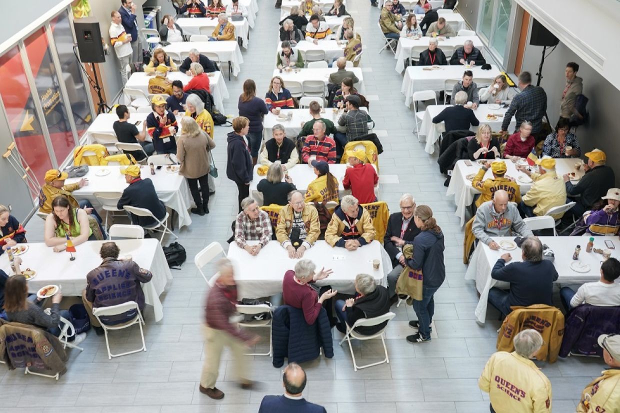 Aerial view of alumni sitting at tables during breakfast