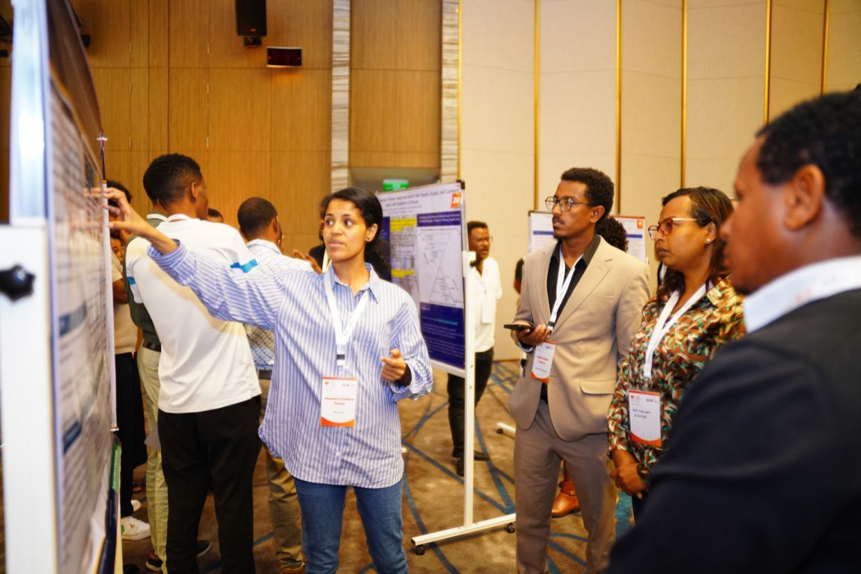 Individuals interact with research displays at a May 2026 conference in Addis Ababa, highlighting a decade of academic collaboration.