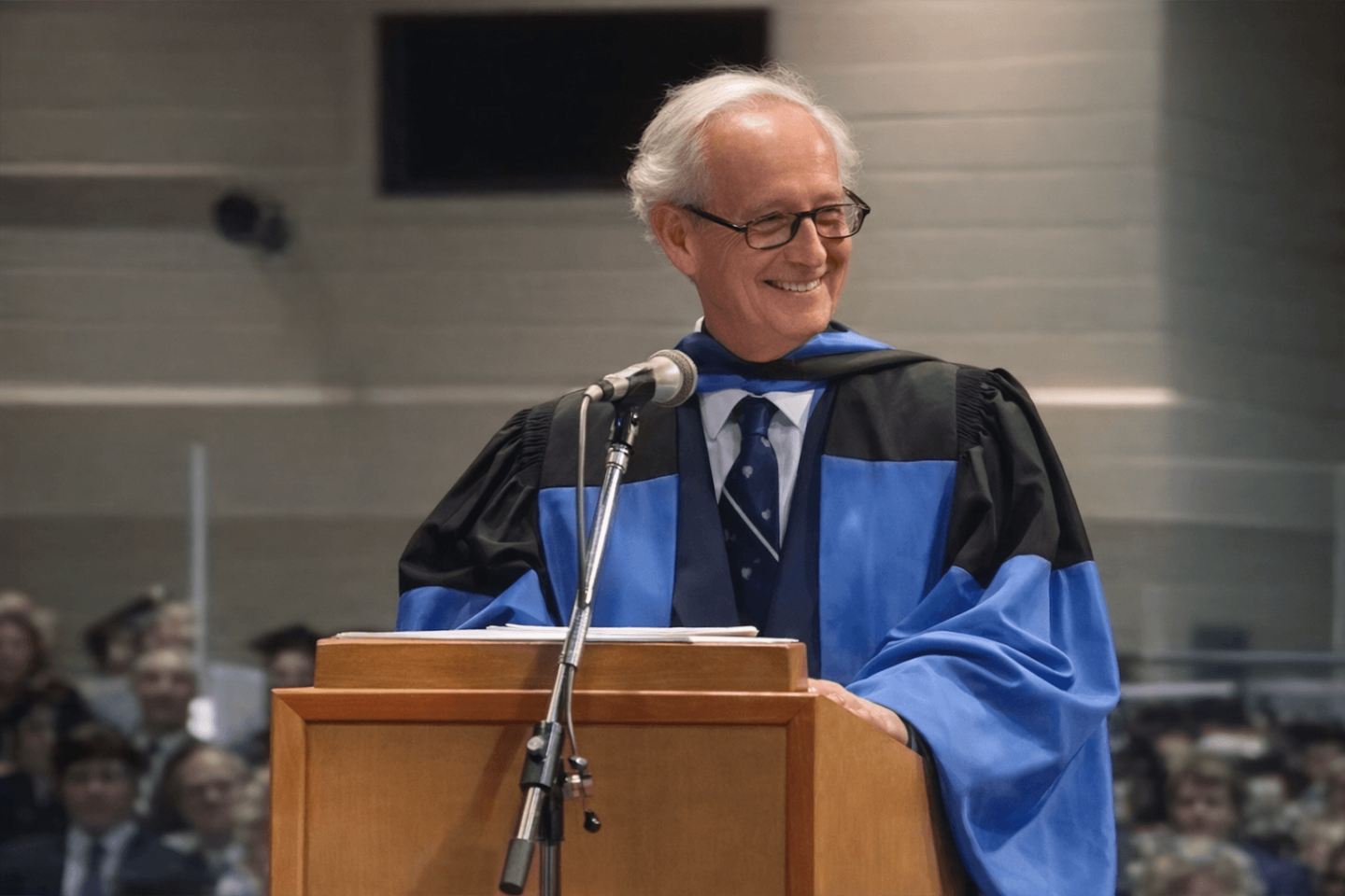 Stephen A. Jarislowsky in a graduation robe delivering a speech at Queen’s University during his honorary Doctor of Laws ceremony.