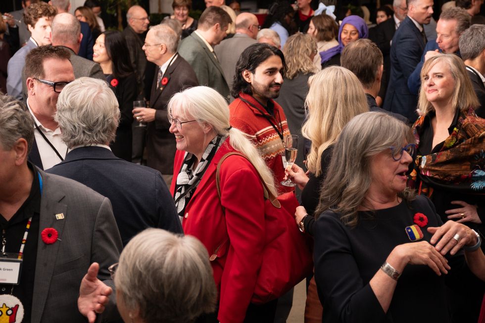 Members of the Queen’s community gather for a reception honouring the 2025 recipients of the Distinguished Service Awards at the Isabel Bader Centre for the Performing Arts on Nov. 7, 2025. (Photo: Stephen Wild)