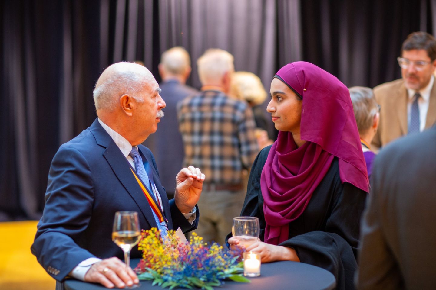 Alumni have a conversation at the Tricolour Guard Reception and Dinner during Homecoming 2025, part of the QUAA’s broader work to keep alumni connected. (Photo: Scott Adamson) 