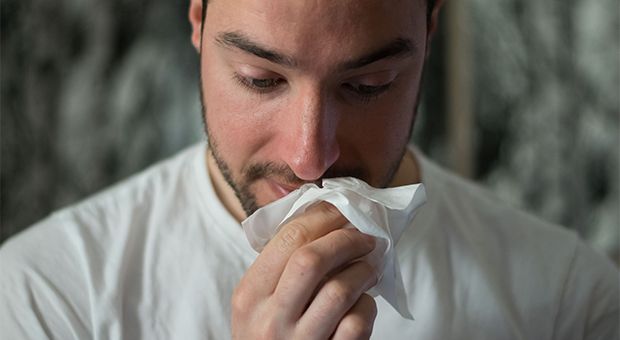 Man wiping his nose